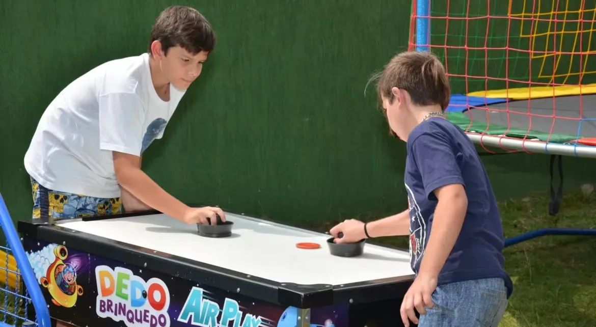 Crianças brincando em brinquedos infláveis alugados nas férias de janeiro
